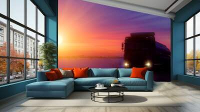 Silhouette Truck with container on highway, cargo transportation concept. Sunset background with copy space Wall mural