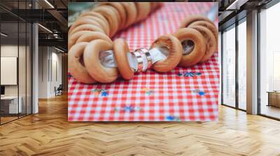 Wedding gold rings close-up on a background of sweet, tasty bagels. Russian, Ukrainian traditions. Photography, concept. Wall mural