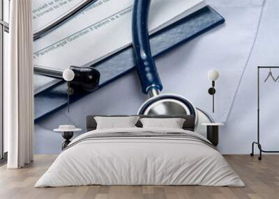 A stethoscope  and a clipboard on a medical uniform, closeup Wall mural