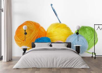 Many colorful balls of yarn in various sizes isolated on white with single crochet hook. Wall mural