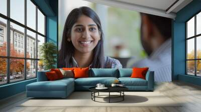 a smiling woman having a conversation with a man Wall mural