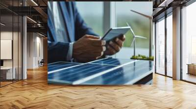 Green or energy renewable concept with a busy professional man is standing with solar panel and using a tablet device. closeup image. Wall mural