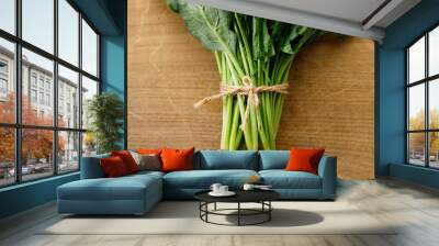 Fresh spinach on wooden background. Wall mural