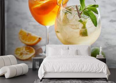 two cocktails with lime and ice over grey background Wall mural