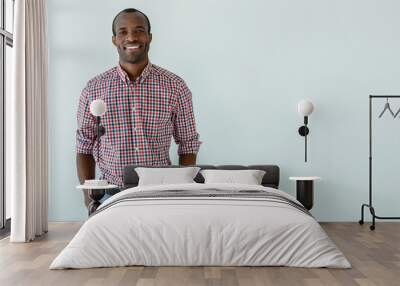 Cheerful afro american man smiling against white background Wall mural