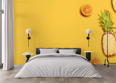 Pineapples, oranges, lemons, coconuts on yellow background. Summer fruits. Flat lay, top view, copy space Wall mural