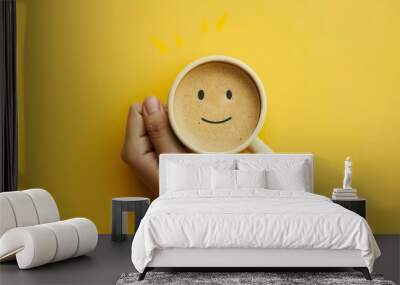 Holding a cup of coffee in one hand, the emotional expression of coffee, with a yellow background, this concept describes feelings of sadness and depression in the morning or at the end of the workday Wall mural