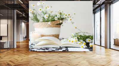 An open book and a bouquet of daisies, atmospheric aesthetic photography Wall mural