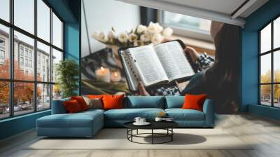 Girl holding an open bible in her hands, home study concept Wall mural