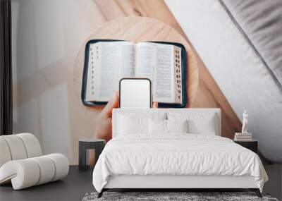 Woman hand hold and touch screen smart phone,cellphone in church over blurred bible holy and age book. Wall mural