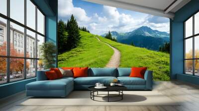 A scenic path winding through vibrant green meadows, framed by majestic mountains and a bright blue sky. Wall mural