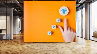 Hand with light bulb icon on background for creative idea concept, Innovative solution for business, Creative thinking, Business success idea of learning, planning or working Wall mural