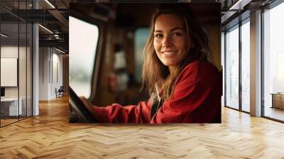 Happy young woman truck driver sitting in truck and looking at camera with smile, People working with transportation, Truck driver occupation, Truck cabin with hands on steering wheel, AI Generated Wall mural