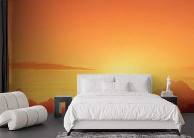 Stunning orange sunset over the horizon with clouds and serene sky, perfect for nature and landscape themes. Wall mural