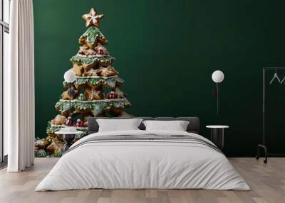 Gingerbread Christmas tree with icing and ornaments on a green background with copy space. Wall mural