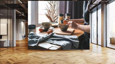 girl is preparing food dinner in the kitchen of her cozy home.home cooking, at home dining Slow cooking, comfort, mood. Slow moments of life, wellness and self love Wall mural