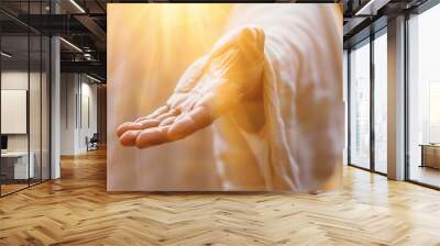 Jesus reaching out his hand against dark background Resurrected Jesus Christ reaching out hand and praying Wall mural