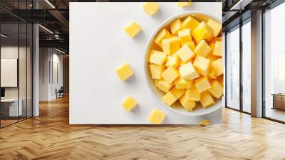 A bowl of butter cubes isolated on white background Wall mural