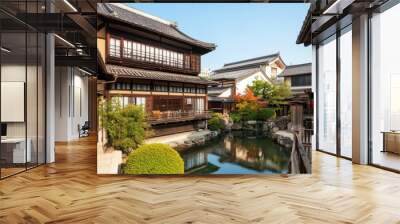 A traditional Japanese house by a calm pond surrounded by an autumn garden with colorful trees and peaceful reflections. Wall mural