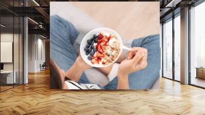 Asian Woman having delicious healthy breakfast at home on morning. Health care female eats yogurt with granola and berry fruit. Healthy food, Vitamins, clean diet, dieting, detox, organic food. Wall mural