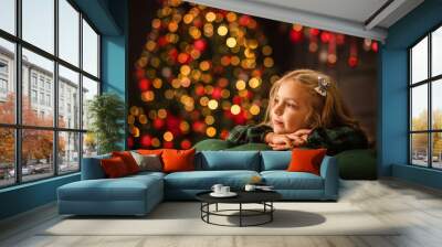 portrait of a beautiful girl on the background of a Christmas tree with lights Wall mural