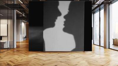 Young bride with groom silhouette on light background Wall mural