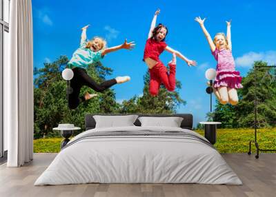 Happy active children jumping Wall mural