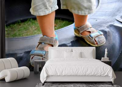 Little boy's feet in worn out summer sandals. Wall mural