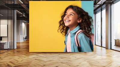 Portrait of smiling schoolgirl with school bag isolated on yellow background. Back to school concept. AI Generated. Wall mural