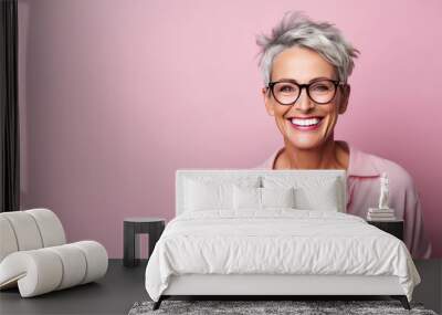 Smiling attractive woman 50s years old look to the camera, wearing glasses, isolated on plain pink background studio portrait. People lifestyle concept. AI Generated. Wall mural