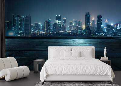 A city skyline at night with a dark sky and a few clouds. Wall mural