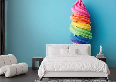 Rainbow color ice cream in a cone on a blue background Wall mural