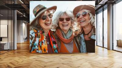 Three women wearing sunglasses and hats are smiling and laughing together. generative ai. Wall mural