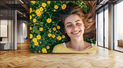 Top view of happy amazing woman lying on grass Wall mural