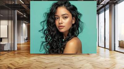 25 year old latina woman with gorgeous twisted curls, long hair coming down from shoulders, posing on pastel mono color solid background Wall mural