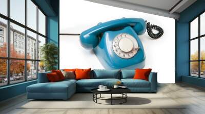 A blue old retro rotary mechanical phone isolated on a white background. Wall mural