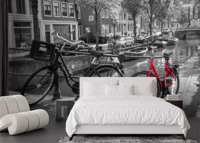 A picture of a red bike on the bridge over the channel in Amsterdam. The background is black and white.  Wall mural