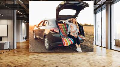 Family and travel concept, Happy family, mom and child enjoying the trip by car Wall mural