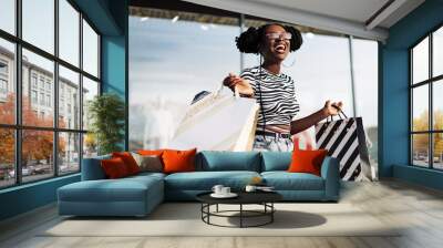 stylish african american woman, after shopping near the store, shopping on black friday Wall mural