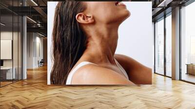 A woman with long, wet hair sits with her head tilted back after washing. Taking care of your hair and scalp Wall mural