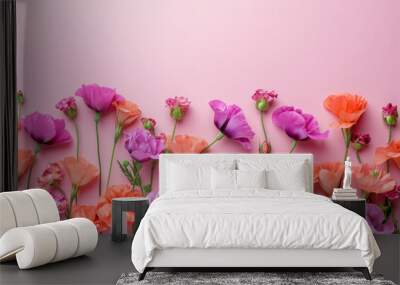 Beautiful spring flowers arrangement on pink background with copy space, flat lay, top view concept for greetings card Wall mural