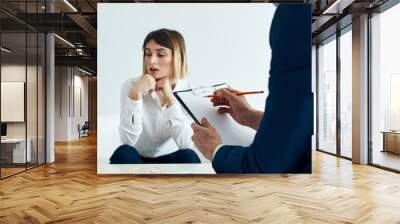 business man in blue jacket and women in the background at the table Wall mural