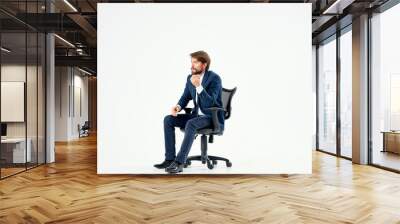 business man sitting on a chair on a white background Wall mural