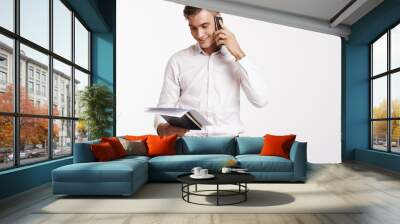 business man talking on the phone and looking at papers Wall mural