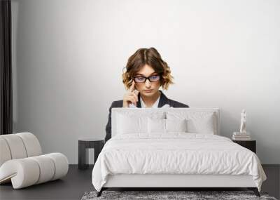 Business woman in a classic suit with a notebook in her hand and glasses on her face Copy Space Wall mural