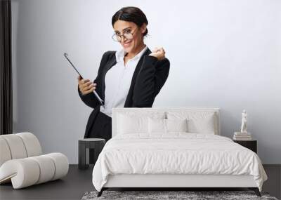 Business woman with a folder of documents in her hands in a black business suit and glasses shows signals gestures and emotions on a white background, work freelancer online training Wall mural