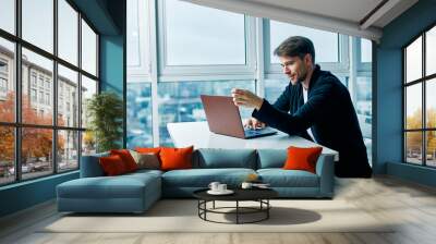 businessman working on laptop in office Wall mural