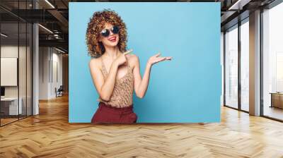 Charming model Curly hair gestures with hands smile blue background Copy Space  Wall mural