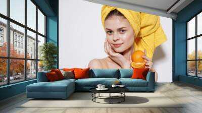 Cheerful woman with bared shoulders oranges in the hands of citrus skin care vitamins health Wall mural