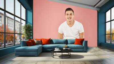 Cute man in t-shirt studio pink background fun Wall mural